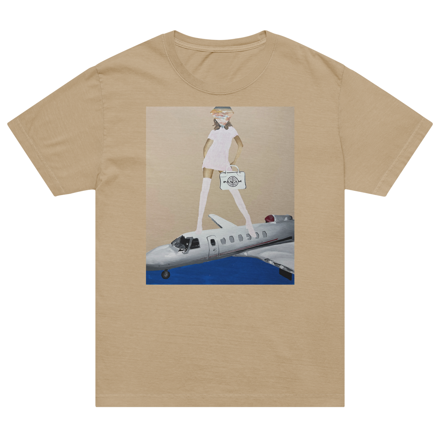 A beige short-sleeve crewneck t-shirt featuring a central graphic print of a cartoonish figure in a white dress standing on a silver airplane against a blue sky and beige background. Daniel Maltzman artist. 