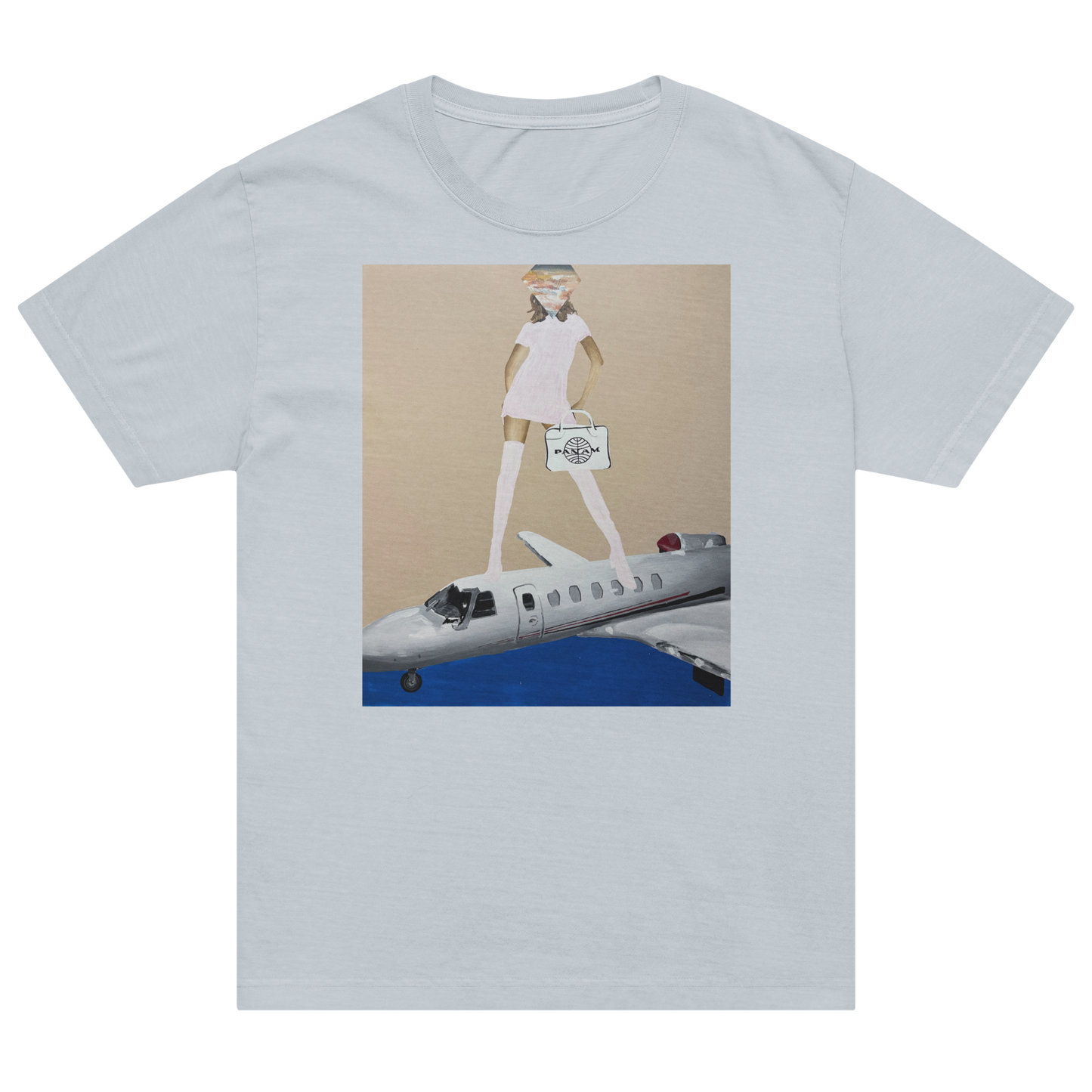 A light gray short-sleeve crewneck t-shirt featuring a central graphic print of a cartoon figure in a white dress standing on a silver airplane against a beige and blue background. Daniel Maltzman artist. 