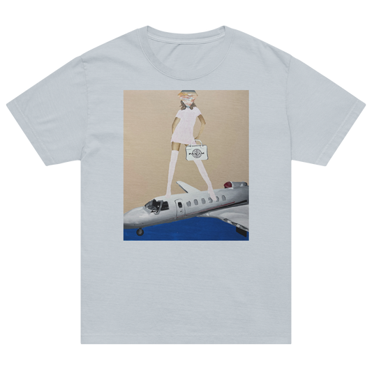 A light gray short-sleeve crewneck t-shirt featuring a central graphic print of a cartoon figure in a white dress standing on a silver airplane against a beige and blue background. Daniel Maltzman artist. 