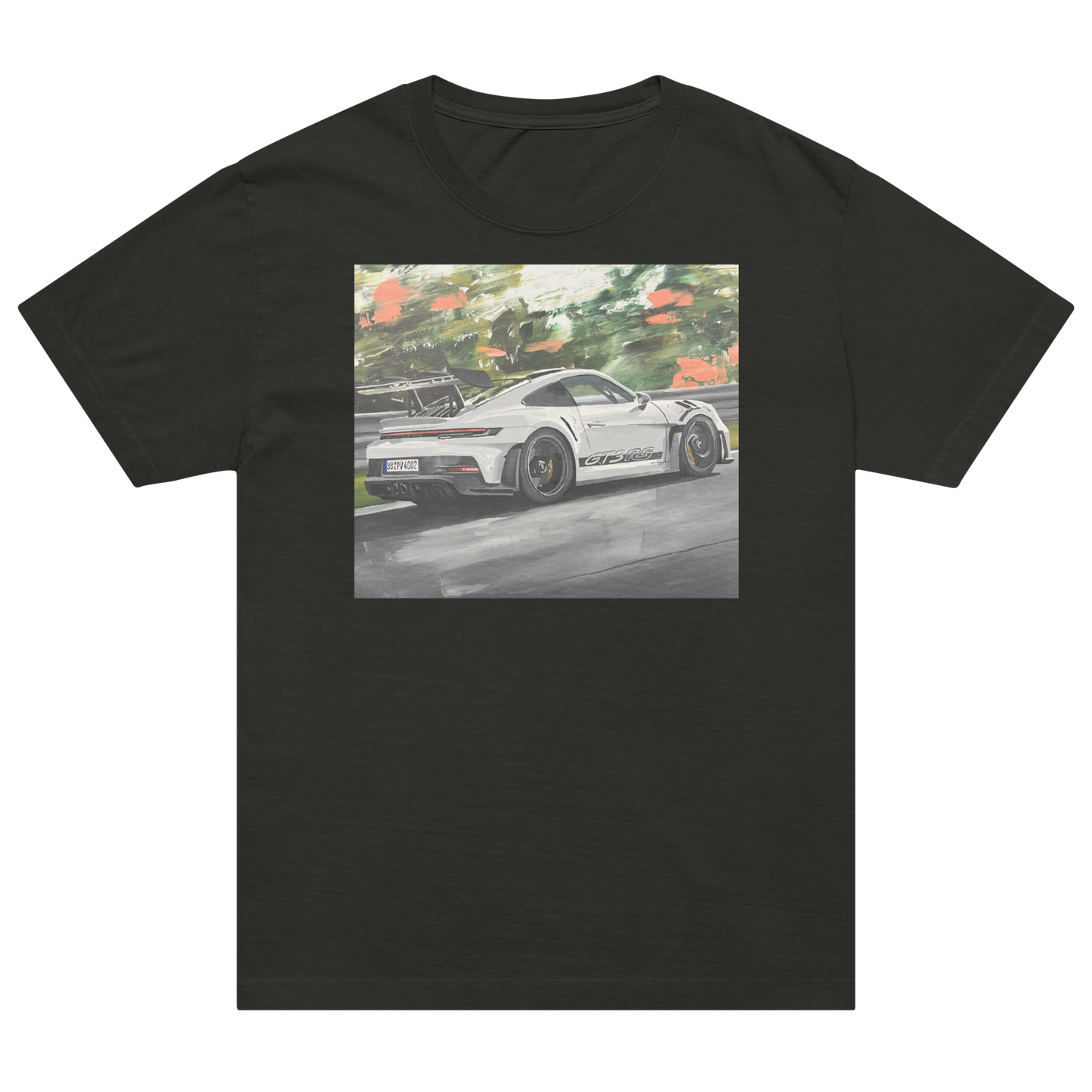 A black short-sleeve crewneck t-shirt featuring a square graphic print of a white sports car on a racetrack with green trees in the background. Daniel Maltzman artist.