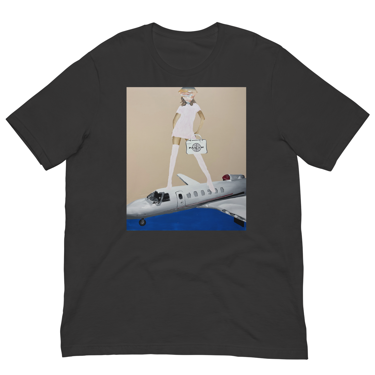 A dark charcoal gray short-sleeve t-shirt with a central graphic print. The print features a stylized illustration of a woman with long white legs and a hat, holding a suitcase, standing on top of a white and blue private jet against a beige background. Daniel Maltzman artist.
