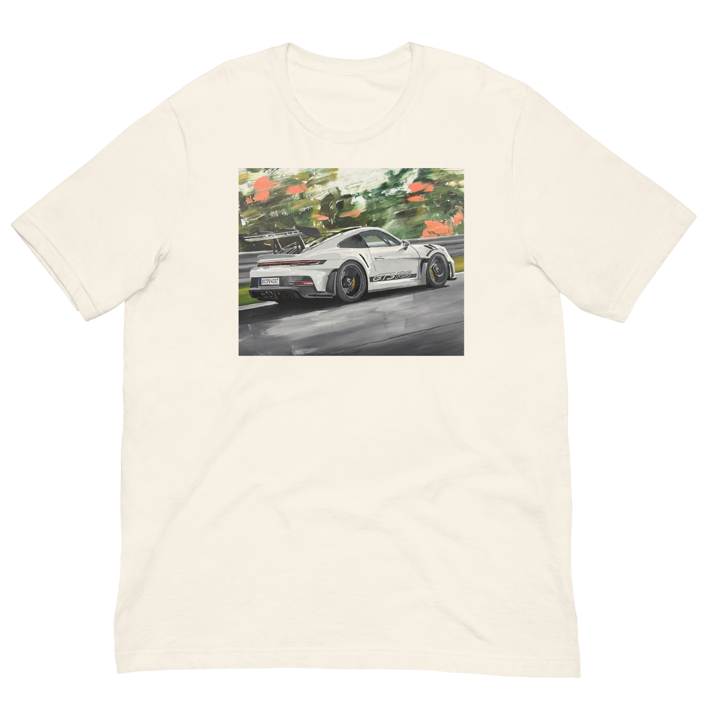An off-white crewneck t-shirt featuring a rectangular graphic print of a white sports car on a wet racetrack with green foliage in the background. Daniel Maltzman original desgn.
