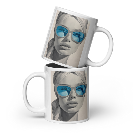 Two white ceramic mugs stacked and overlapping on a light gray background. The mugs feature a printed graphic of a woman's face wearing blue-tinted sunglasses. Daniel Maltzman artist.