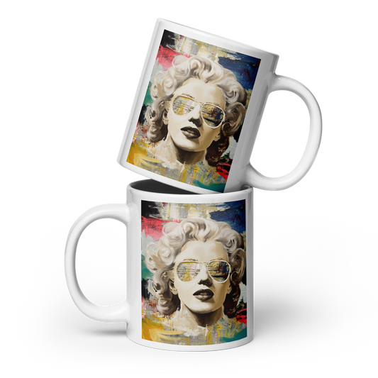 Two white ceramic mugs stacked diagonally, featuring a colorful pop-art style portrait of Marilyn Monroe wearing sunglasses on the side. Daniel Maltzman artist.