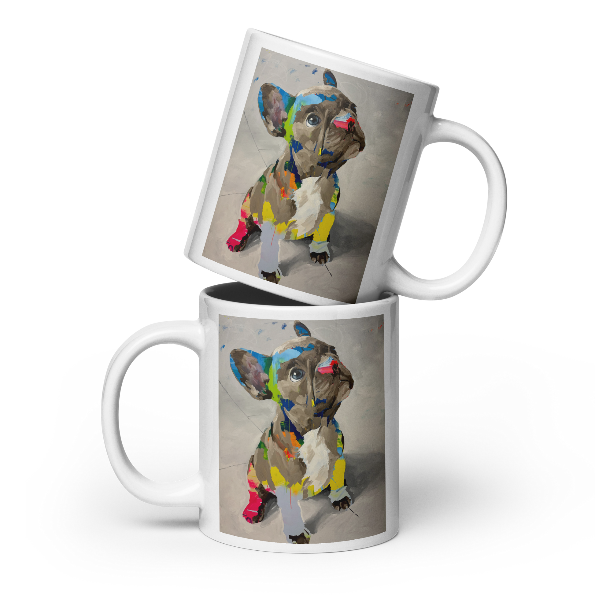 Two white ceramic mugs stacked with a French bulldog illustration printed on the side, shown on a clean white background. Daniel Maltzman artist.