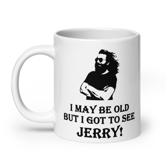 A white ceramic mug with a black graphic of a bearded man wearing sunglasses and the text 'I MAY BE OLD BUT I GOT TO SEE JERRY!' printed on the side.
