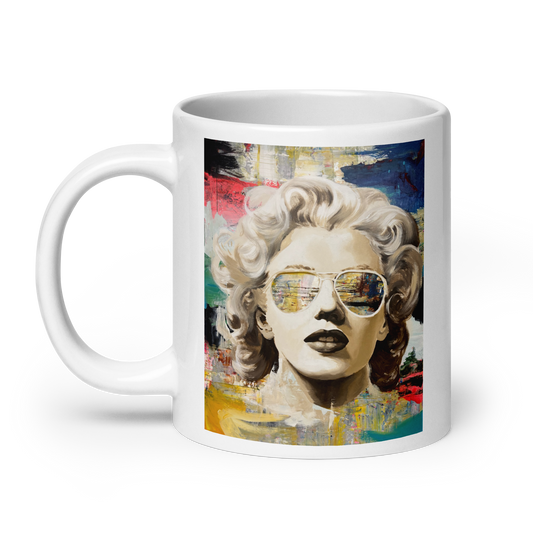 A white ceramic mug featuring a colorful pop-art style portrait of Marilyn Monroe wearing aviator sunglasses, shown on a clean white background. Daniel Maltzman original design.