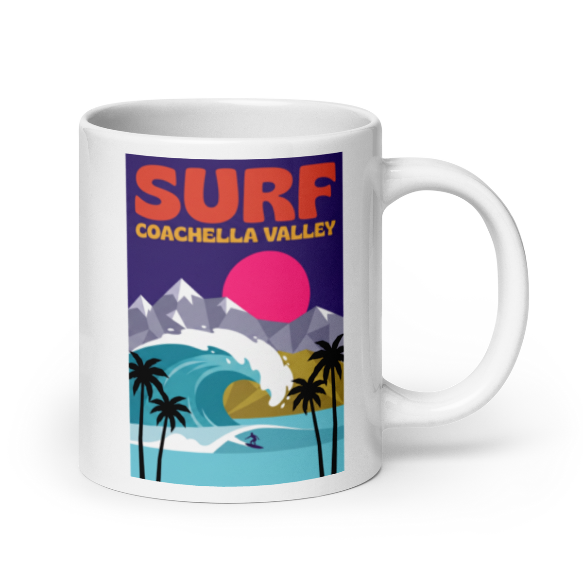 A white ceramic coffee mug featuring a colorful retro-style graphic print that reads 'SURF COACHELLA VALLEY' above an illustration of a wave, mountains, palm trees, and a pink sun.