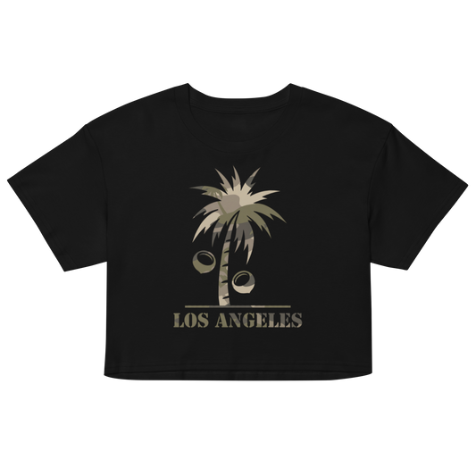 A black short-sleeve cropped t-shirt featuring a distressed graphic of a palm tree with coconuts and the text 'LOS ANGELES' in a muted olive-beige color, displayed on a solid white background.