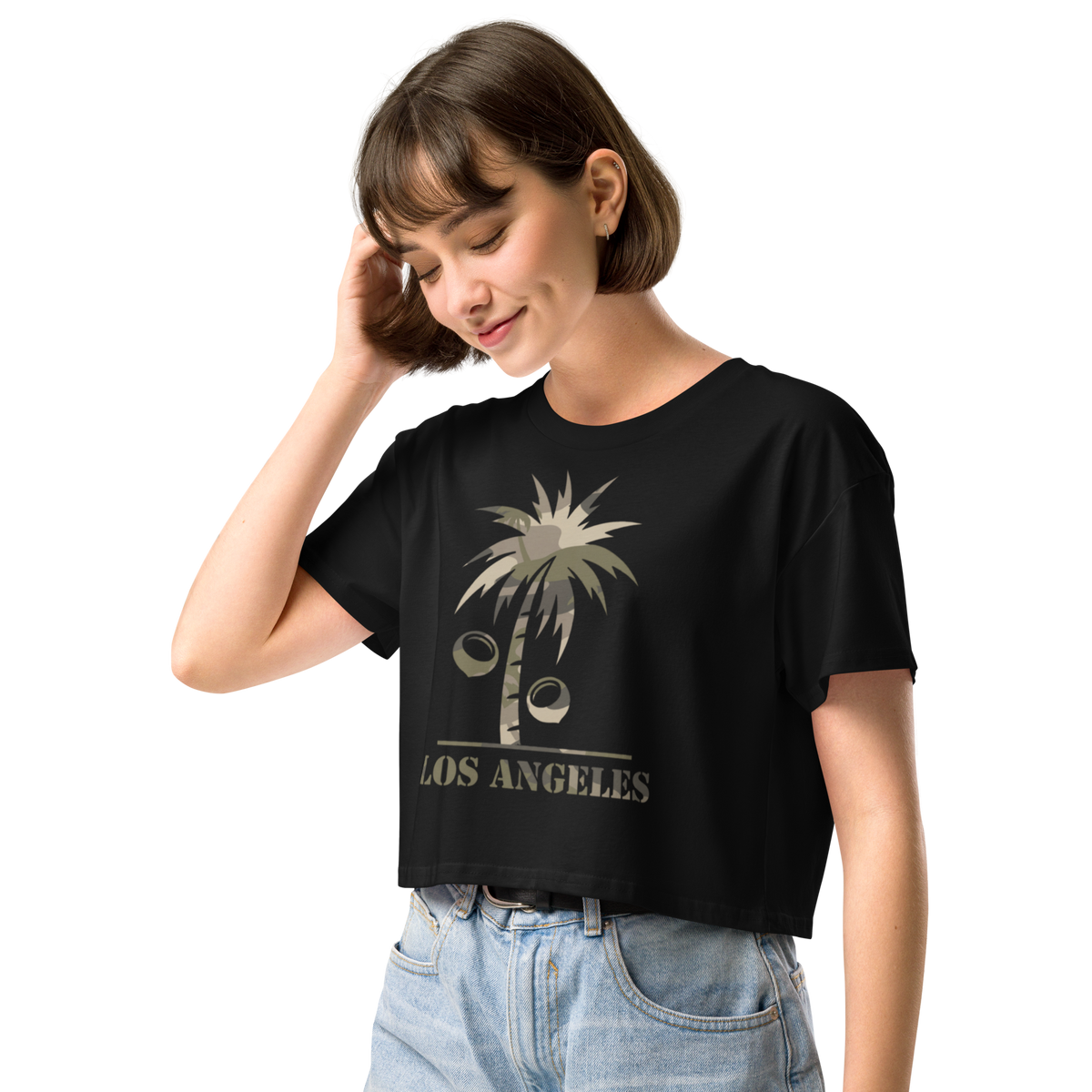 Woman wearing a black t-shirt with a graphic design of a camo pattern on a Palm Tree and coconuts with the text 'Los Angeles'