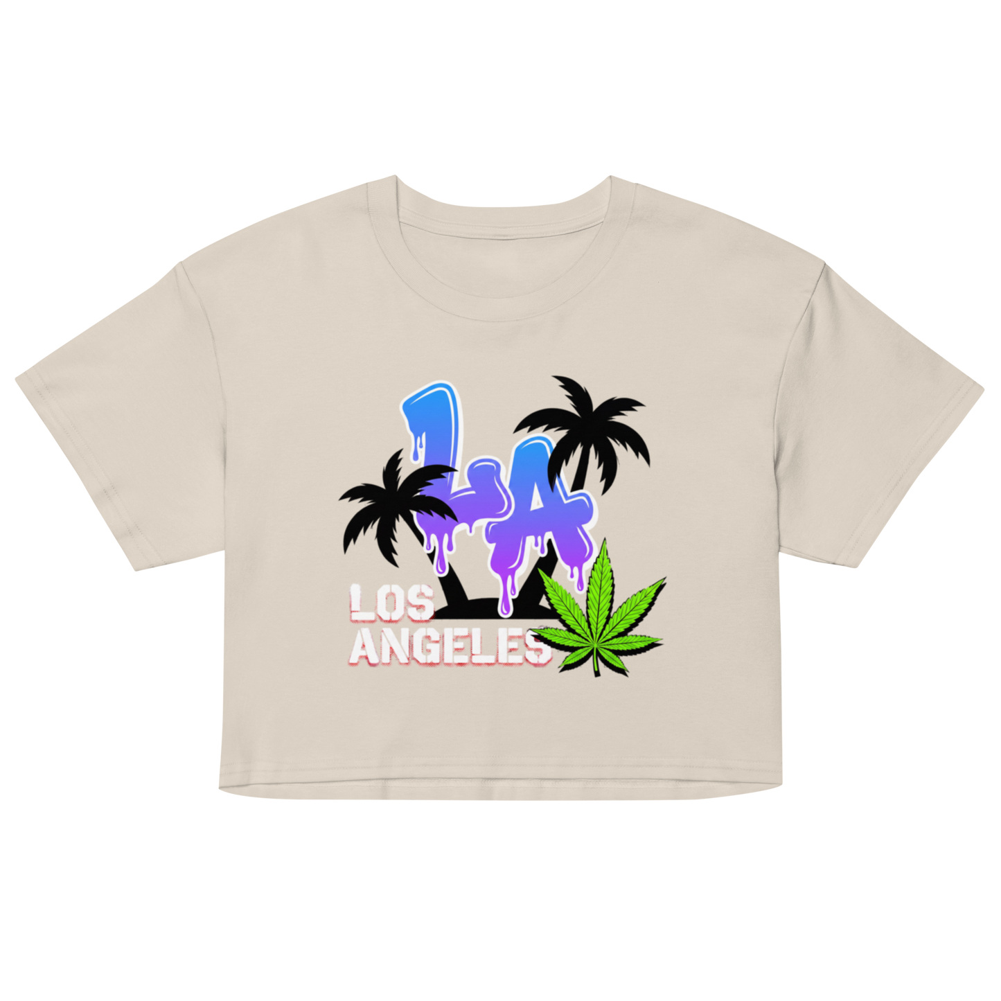 A beige short-sleeve crop top featuring a colorful graphic print of the letters 'LA' in blue and purple with black palm trees, 'LOS ANGELES' in pink and white, and a green cannabis leaf on a plain white background.