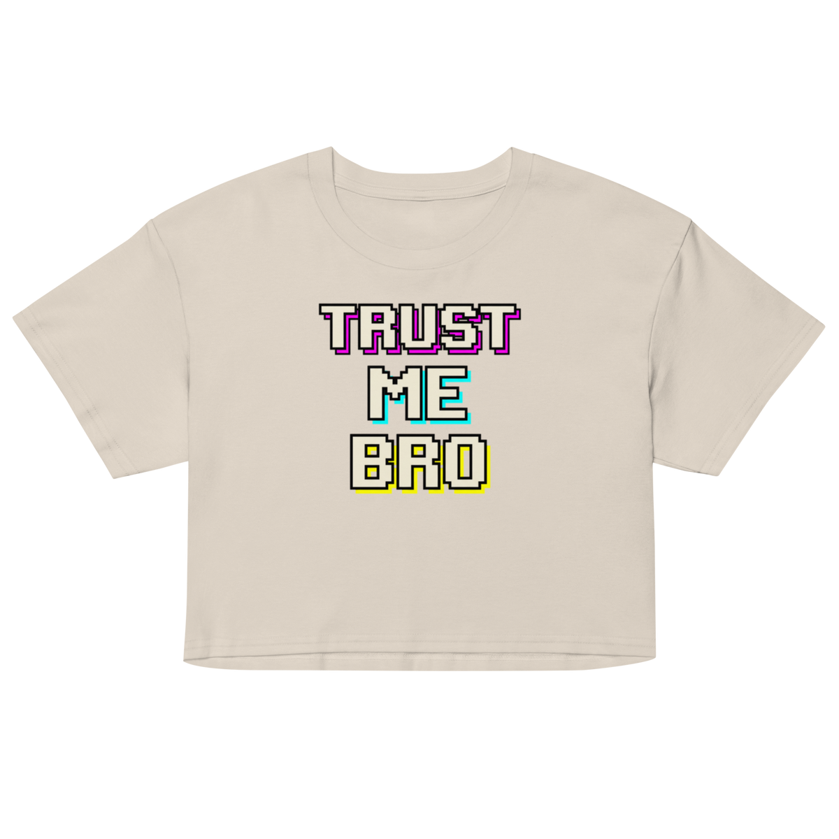 A light beige short-sleeve crop top t-shirt featuring a retro pixelated graphic that reads 'TRUST ME BRO' in purple, cyan, and yellow text with black outlines.