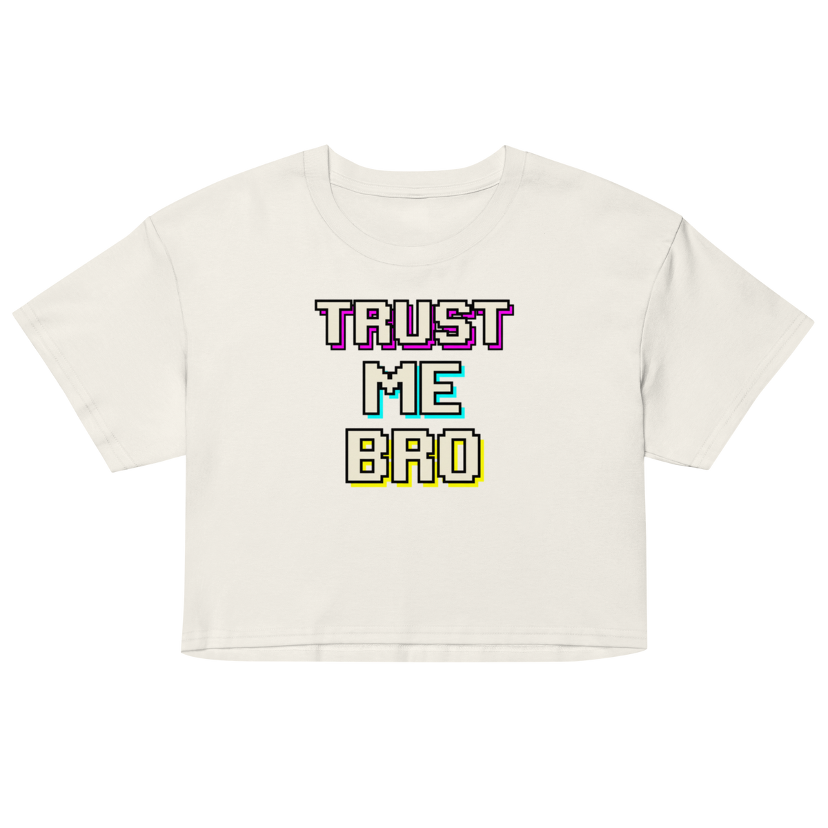 An off-white cropped t-shirt with a colorful retro pixelated text graphic reading 'TRUST ME BRO' on the chest, displayed against a solid white background.
