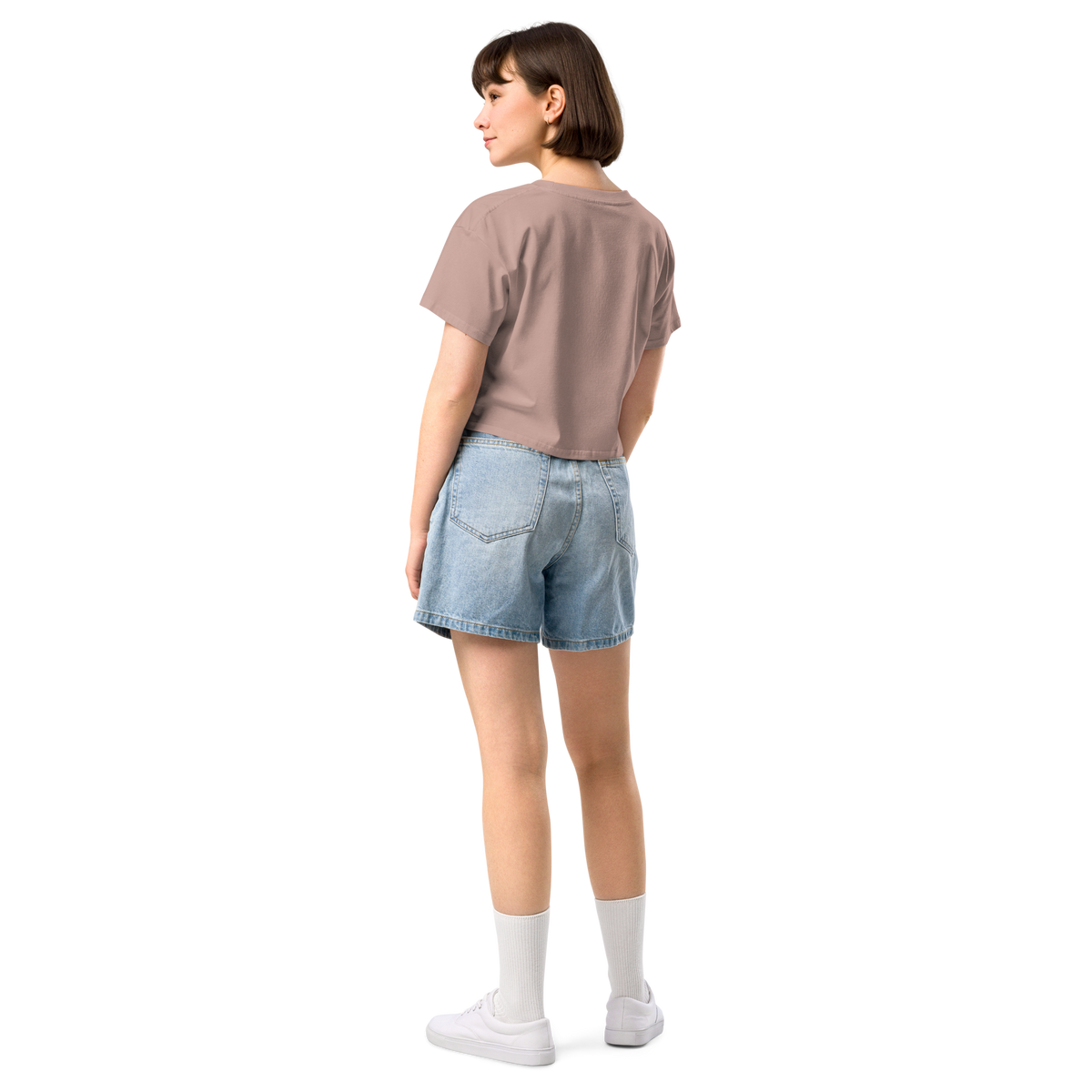 Person wearing a brown t-shirt and denim shorts on a white background