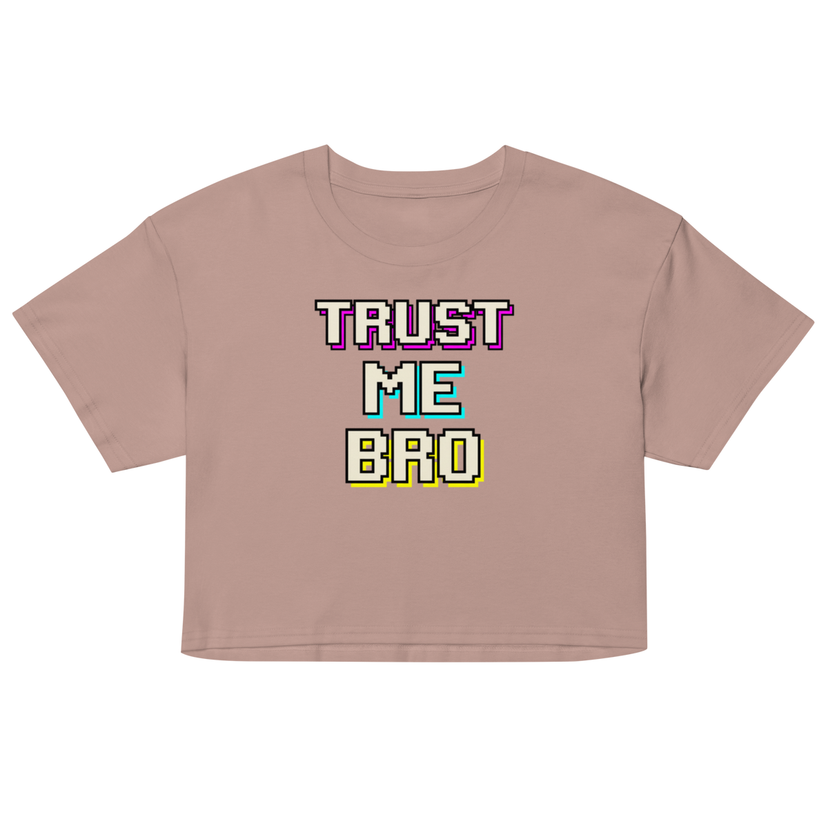 A cropped short-sleeve t-shirt in a dusty rose color, featuring a retro pixelated graphic on the chest that reads 'TRUST ME BRO' in purple, teal, and yellow block letters with white outlines.