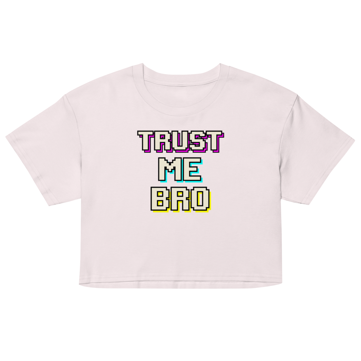 A light pink short-sleeve crop top t-shirt featuring a retro pixelated text graphic that reads 'TRUST ME BRO' in purple, cyan, and yellow colors, displayed on a clean white background.