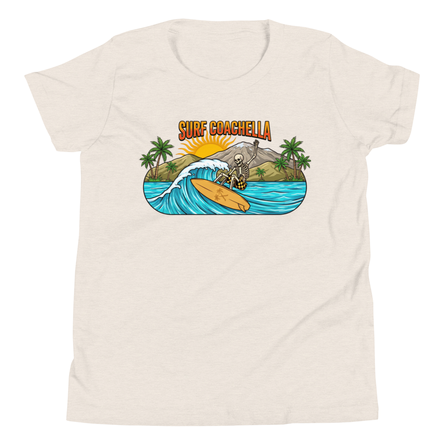 A cream-colored short-sleeve t-shirt with a colorful graphic on the chest depicting a surfer on a wave with the text 'SURF COACHELLA' above it, shown against a plain white background.
