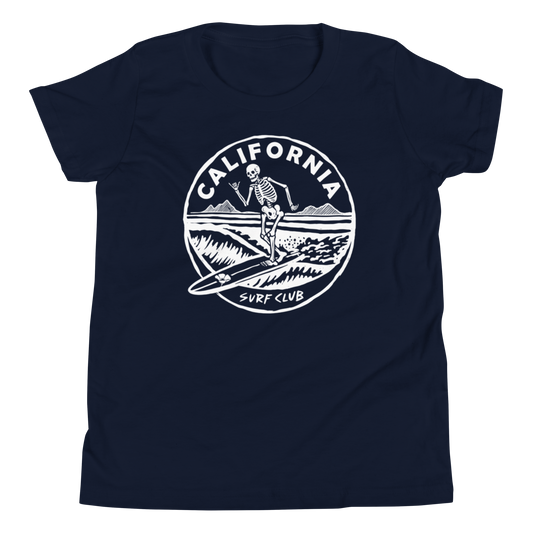 A navy blue short-sleeve t-shirt with a white circular graphic on the chest featuring a skeleton surfer and the text 'CALIFORNIA SURF CLUB'.