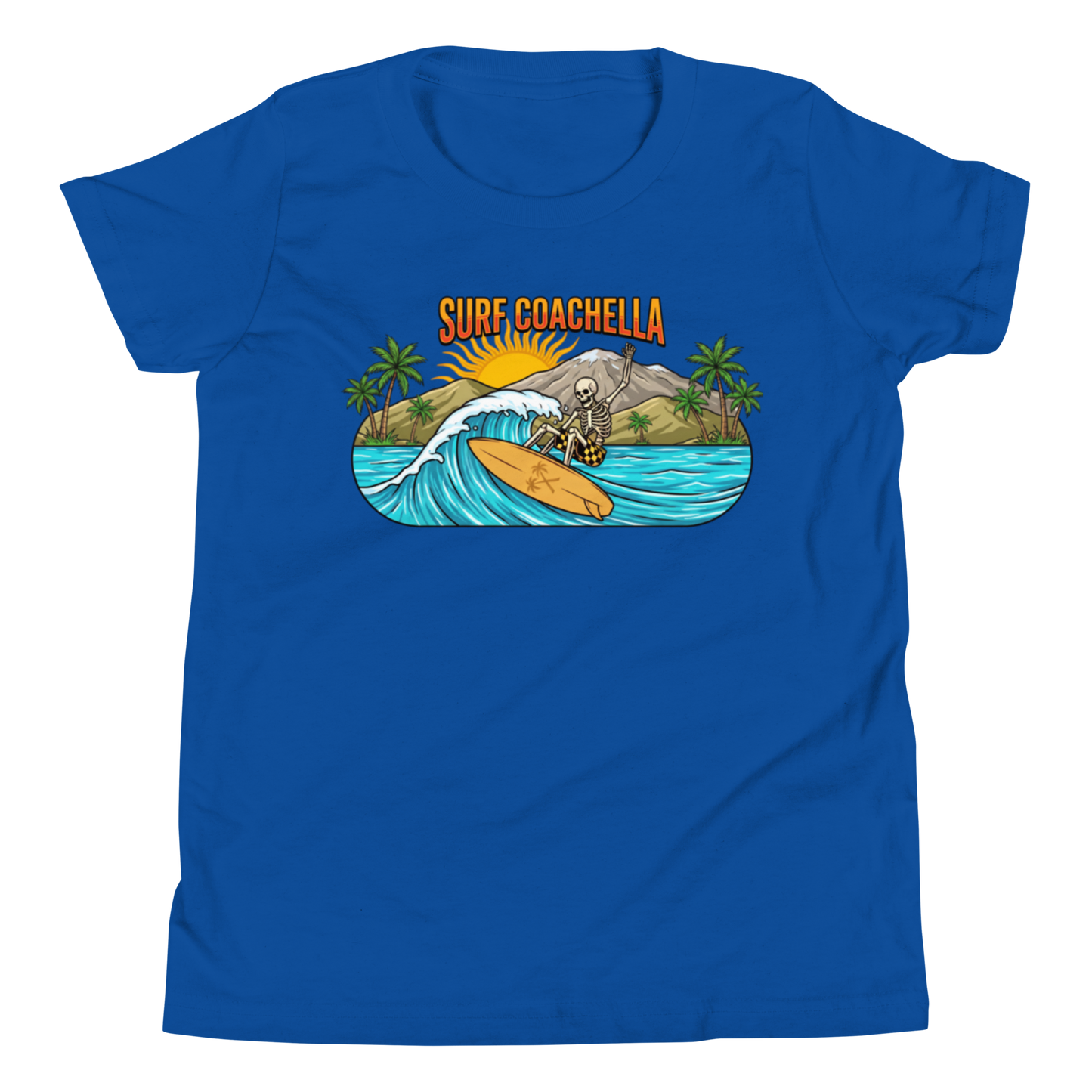 A royal blue short-sleeve crewneck t-shirt featuring a colorful graphic print on the chest. The graphic shows a skeleton surfer riding a wave with palm trees, mountains, and a sun, with the text 'SURF COACHELLA' in orange above.